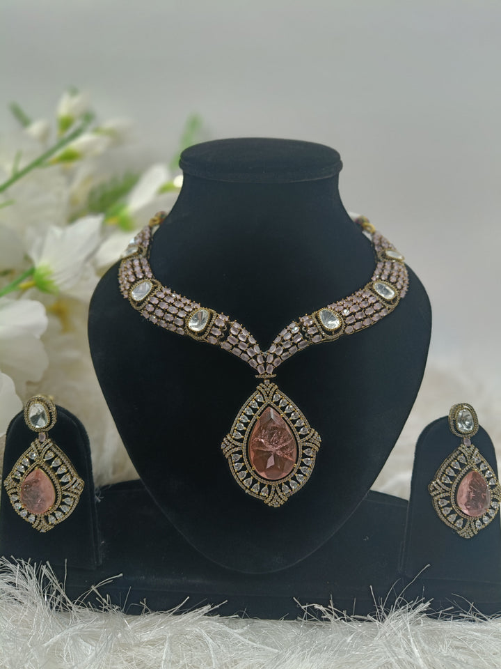 Elegant pink gemstone necklace with gold accents, featuring a delicate pendant design that exudes sophistication and charm.