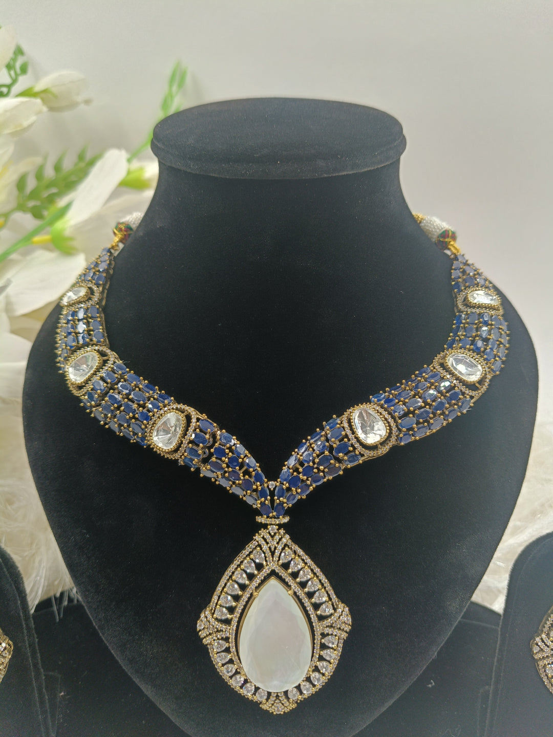 Elegant pink gemstone necklace with gold accents, featuring a delicate pendant design that exudes sophistication and charm.