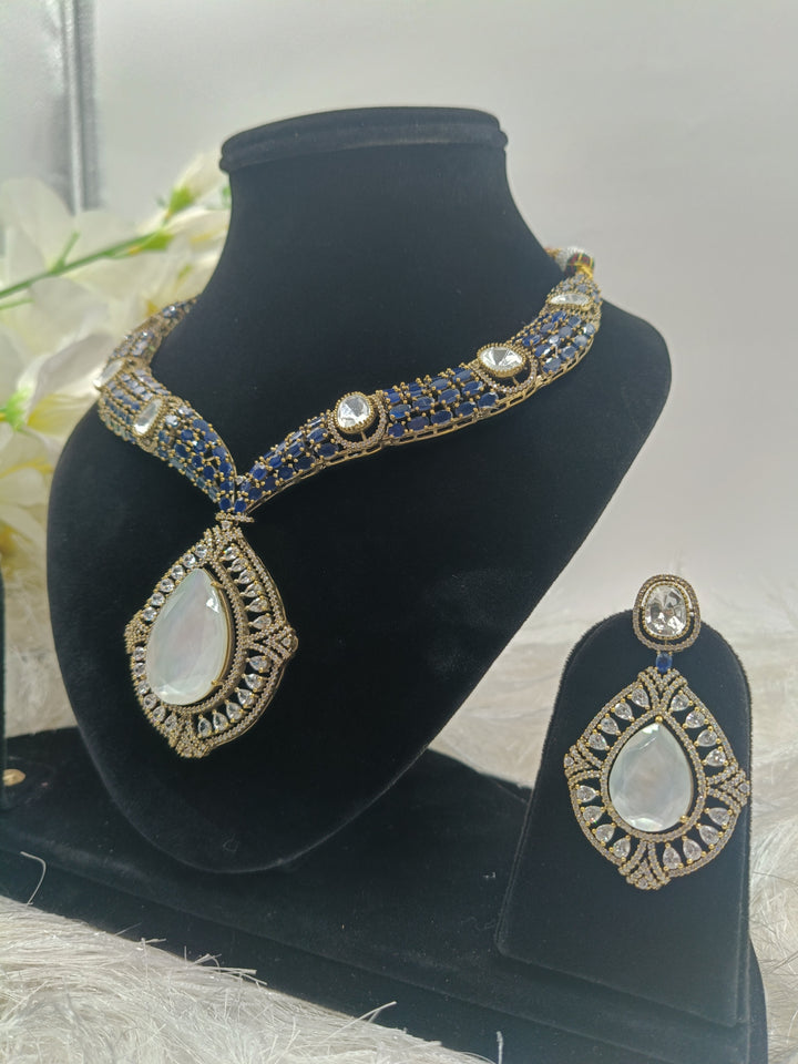 Elegant blue gemstone necklace with gold accents, featuring a delicate pendant design that exudes sophistication and charm.
