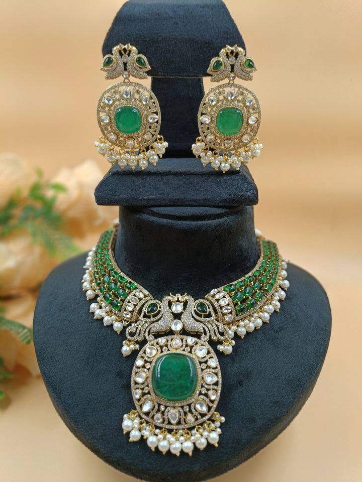 An opulent emerald and pearl necklace featuring two intricately set peacocks, radiating elegance and regal charm.