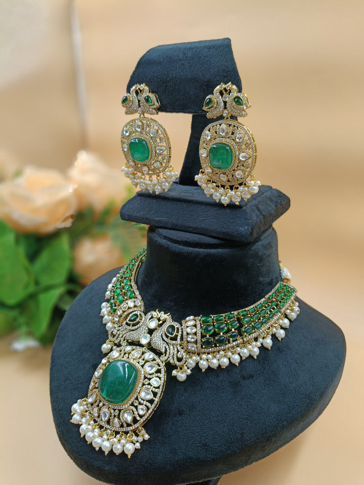 An opulent emerald and pearl necklace featuring two intricately set peacocks, radiating elegance and regal charm.