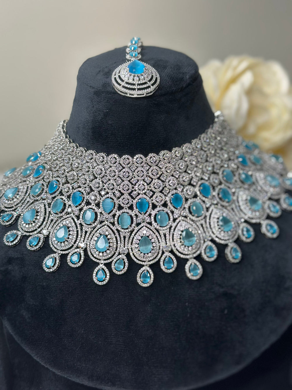 "A distinguished silver necklace showcasing masterful craftsmanship, radiant gemstones, and delicate details, designed to embody timeless luxury."  

