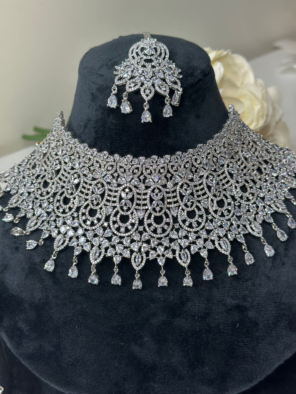 A premium diamond necklace and earrings set on black velvet, showcasing intricate craftsmanship and timeless sophistication, designed to elevate any formal ensemble.